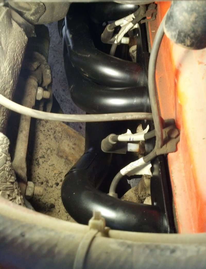 The clean black paint emphasizes the otherwise very dusty/dirty engine bay